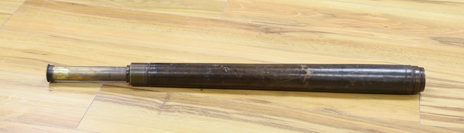 A single draw brass and leather Watkins & Hill telescope, total extended length 74.5cm